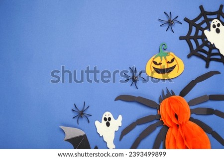 Flat lay composition with Halloween decor on blue background, space for text