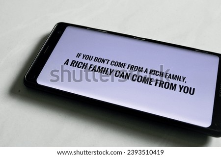 motivational words on a smartphone with the sentence "if you don't come from a rich family, a rich family can come from you. Motivational sentences about Rich. 