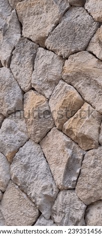 Close up picture of multi edge of natural stone arranged neatly to cover the front wall