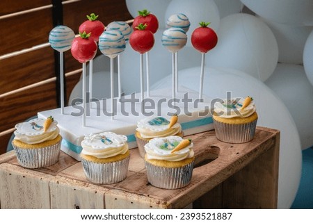 An image of cake pops and cupcakes themed reveals a colorful and delectable display of bite-sized treats, each designed with vibrant frosting