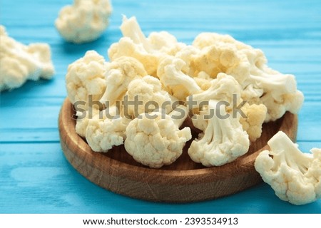 Fresh cauliflower cabbage vegetable on blue background. Healthy natural food. Top view