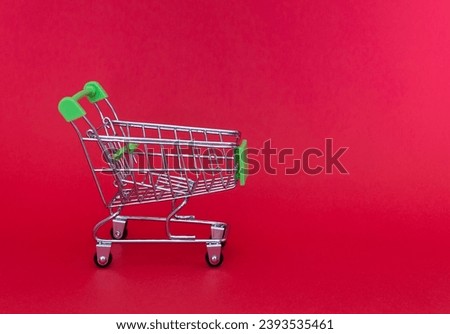 Grocery cart or shopping trolley on a red background