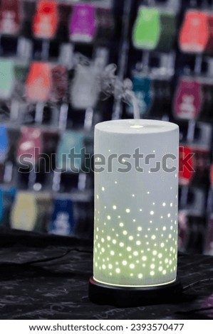 A Scentsy lamp and vapouriser on display at a market stall