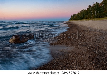 A twilight glow carresses the Lake Superior shore at Hurrican River beach in Pictured Rocks National Lakeshore, Alger County, Michigan