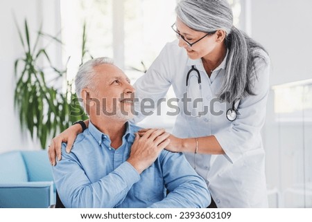 Support concept. Happy senior patient holding doctor for hand while being at hospital. First aid, trust and psychological support concept.