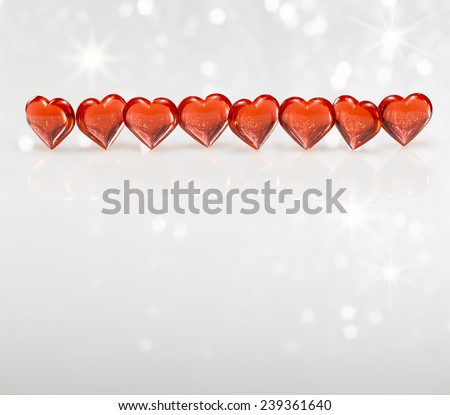 Red hearts on a white sparkle reflective background.