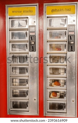 Hot snack vending machine, very popular in the Netherlands, selling traditional Dutch frikadellen, croquettes and Kaassouffles. Royalty-Free Stock Photo #2393616909