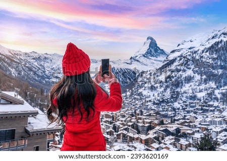 Tourist taking photo at Matterhorn and swiss alps in Zermatt, Switzerland.