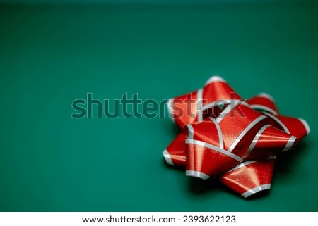 Christmas copy space green background red and white bow in bottom right hand corner background holiday cheer greeting card with your own text or message