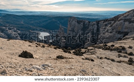 Pyrenean Ascent: Boron's Rocky Journey with Vadiello Reservoir's Barren Beauty, A Wilderness Expedition in Aragon's Alpine Majesty.

 Royalty-Free Stock Photo #2393623307