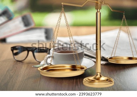 Shiny golden scale with legal paper in office