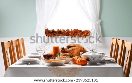 The Thanksgiving table has many dishes, beautifully decorated, and is surrounded by family chairs. Royalty-Free Stock Photo #2393625181