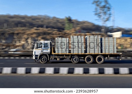 Intentional camera movement, Slow shutter speed motion blur image of a trailer truck speeding on a highway.