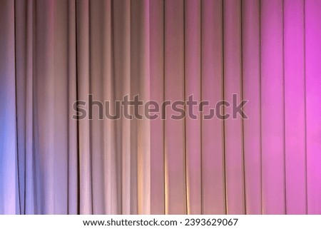 Closed theatrical curtain with pink spot lights, background photo texture