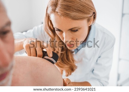Doctor dermatologist examines skin of patient. Dermatoscopy, prevention of melanoma, skin cancer. Royalty-Free Stock Photo #2393641021