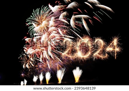 Happy New Year 2024. Beautiful background to New Year 2024 Sparkling burning creative numeral 2024. Fireworks isolated on black background. Overlay design element. Template for holiday greeting card