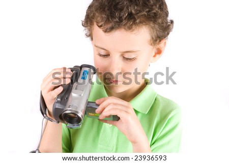 8 year old boy using video camera, isolated on white background