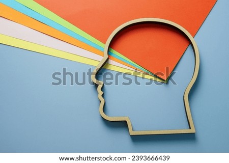 Head outline and colored paper as a symbol of creativity and neurodiversity. Royalty-Free Stock Photo #2393666439