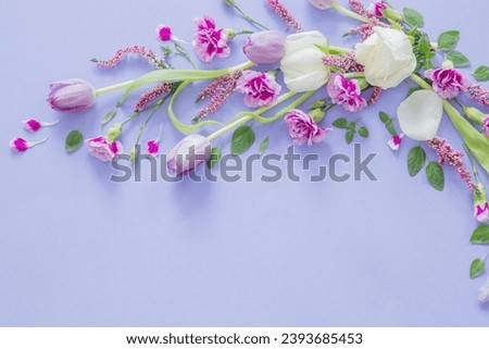 frame of beautiful flowers on purple background