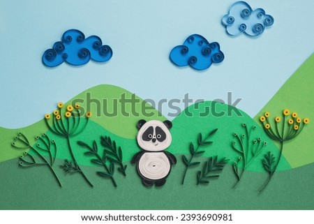 Funny panda quilling character in field, near trees in summer day with clouds. Happy cute panda in garden. Save The Earth Pandas live here. Ecology concept. Hand made of paper quilling technique.