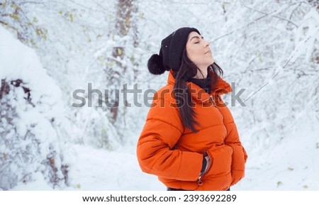 Relaxed woman breathing fresh air in a snowy forest. Winter time Royalty-Free Stock Photo #2393692289