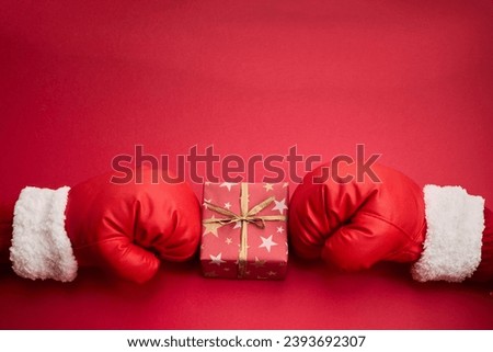 Boxing day shopping creative idea with Santa clause boxing glove Royalty-Free Stock Photo #2393692307