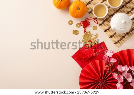 Transport yourself into heart of Chinese New Year: top view fans, Feng Shui artifacts, teapot set, green tea— harmonious family tradition. Tangerines, sakura, pastel backdrop create canvas for your ad