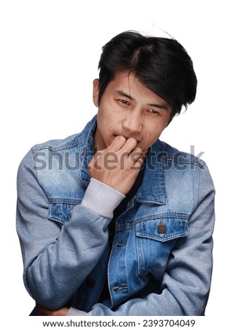 asian man is emotional, excited, in a denim jacket