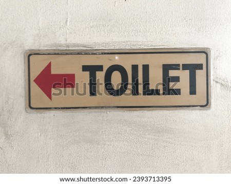 Toilet Sign. It is a directional sign to the toilet, making it easier for visitors to find it. It is important to install it in public areas such as malls and others. Isolated. Copy Space. Background.