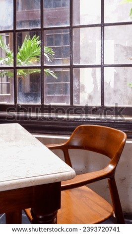chairs and tables in a corner of the cafe, with a window in the background
