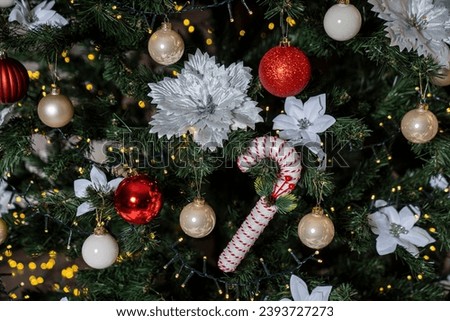 Christmas background with fir tree and decoration. Gifts and accessories. Train, nutcracker, pillow, lettering, lights.