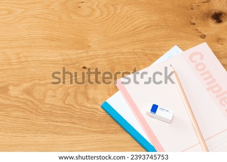 Notebook and writing utensils on the desk.