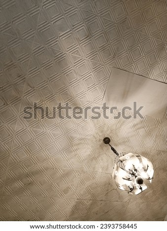 Picture of ceiling with a chandelier light up the room. 