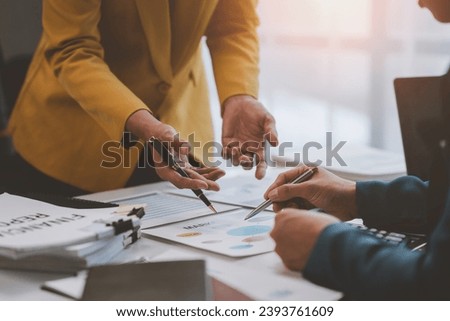 Two Asian businessmen discuss the working information of a financial investment project. Marketing and growth planning strategies Company turnover with laptop computer in office.