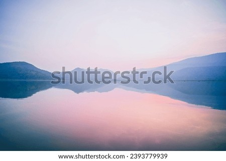 Minimalistic Horizon. Clouds, Mountains, and Lake in Horizontal Panoramic Landscape Royalty-Free Stock Photo #2393779939