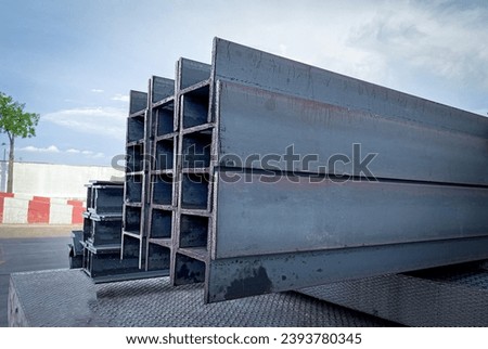 Steel beams production. Metal girders stack on project construction , steel h-beam, selective focus, Raw materials used in building construction. Royalty-Free Stock Photo #2393780345