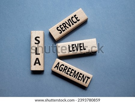 SLA - Service Level Agreement. Wooden blocks with word SLA. Beautiful grey background. Business and Service Level Agreement concept. Copy space.