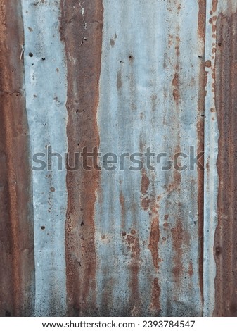 Vertical old and rusty zins sheet wall for vintage background.Metal sheet roof texture.Old zinc surface with the rust.Blank space for design.
