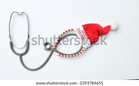 medical stethoscope with  decorated Beautiful headband 
 Decorative red Santa Hat. Background for congratulations to doctors.  life christmas and new year holidays.