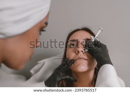 Woman receiving a injection for a lips augmentation in a clinic