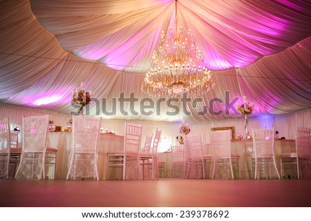 Interior of a wedding tent decoration ready for guests Royalty-Free Stock Photo #239378692