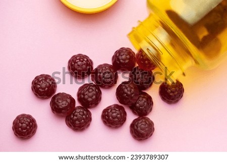 Vitamins for children,   jelly gummy fruits candy on pink  background Royalty-Free Stock Photo #2393789307