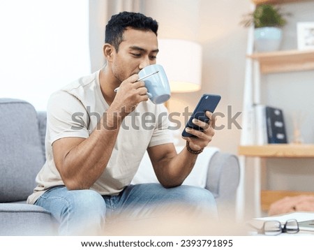 Man, phone and texting with coffee on sofa in home for taste of hot beverage. Asian person, reading and mobile app for finance, message or planning on internet and social media by cellular with drink