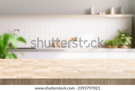Selective focus.End grain wood counter table top on blur white minimal kitchen background.For montage product display or design key visual Royalty-Free Stock Photo #2393797021