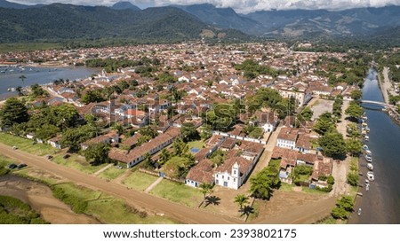 Aerial view to historic town Paraty with green mountains in background on sunny day,  Brazil, Unesco