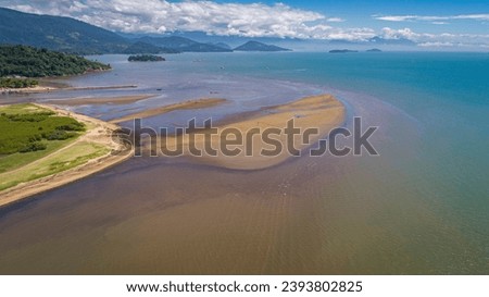 Aerial view ofParaty along  Green Coast with turquoise water, sandbanks and green mountains at low t