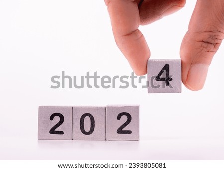 Merry Christmas and Happy New Year concept. Metal cube block change to year 2024, Isolated on white background. Preparation for new year, life, business, plan, goals, target and strategy concept.