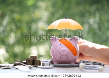 Protection,Piggy bank attached to the plaster on the head and stethoscope on green background, Save money for Medical insurance and Health care concept Royalty-Free Stock Photo #2393809613