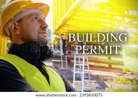 Portrait of young man is engineer wearing helmet smile with satisfied at construction site with the sign "Building permit" . 