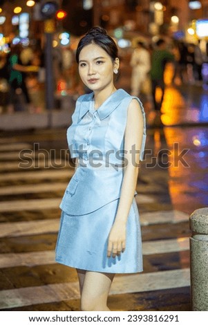 Portrait of Asian young girl posing night outdoors, light of urban, handmade fashion